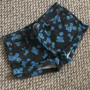 Black washed denim shorts with blue flowers